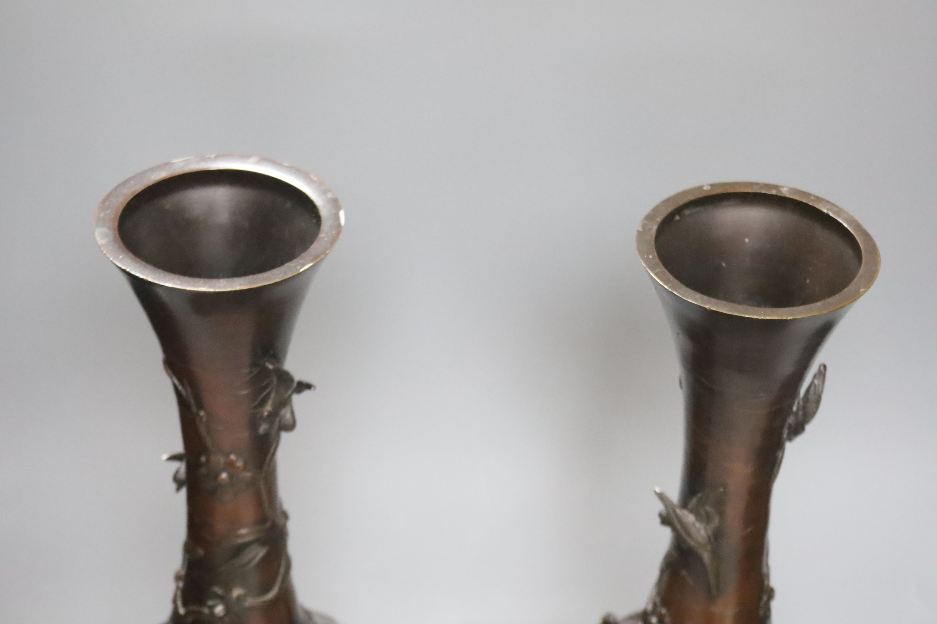 A pair of Japanese Meiji period bronze bottle vases, repaired to neck, height 46cm